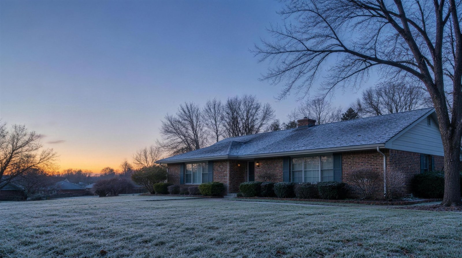 Brick ranch home with frost on its roof at dawn in Hurst, Texas